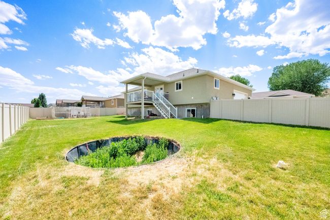 Rear view of property featuring stairway, a fenced backyard, and a deck | Image 27