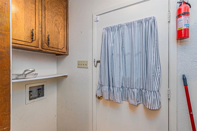 Clothes washing area with hookup for a washing machine and cabinet space | Image 27