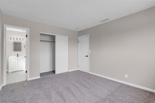 Unfurnished bedroom with a sink, baseboards, visible vents, a closet, and carpet floors | Image 21