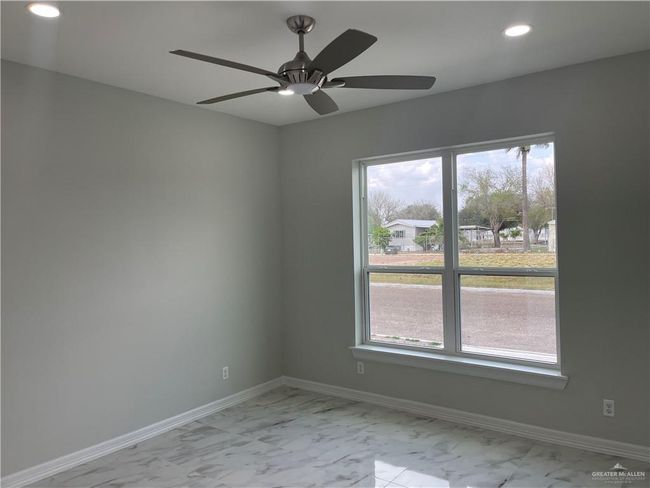 Spare room featuring light marble finish flooring, recessed lighting, baseboards, and ceiling fan | Image 8