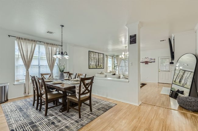 Dining room with a chandelier and light wood-type flooring | Image 11