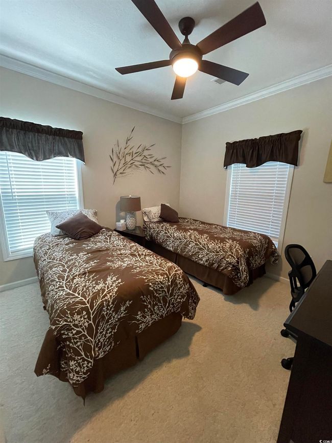 Carpeted bedroom with Crown Molding, & Ceiling Fan. | Image 20