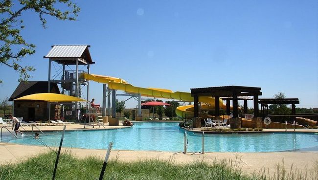 Community pool featuring a water slide | Image 26