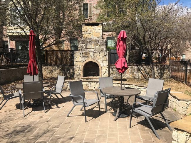 View of patio / terrace featuring an outdoor stone fireplace and outdoor dining area | Image 20