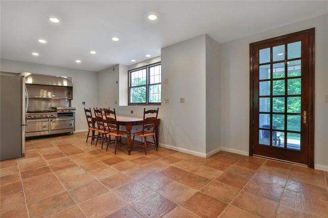 Open Eat-in kitchen with access to the screen porch and pool awaits your inspiration | Image 10