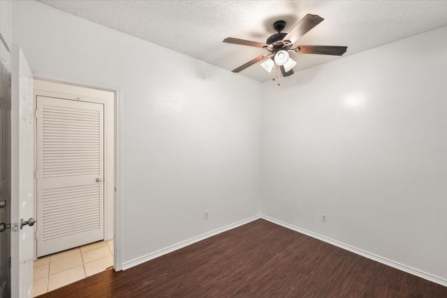 Spare room with a ceiling fan, wood finished floors, and a textured ceiling | Image 13