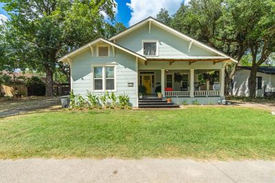 Bungalow-style home with a front lawn and covered porch | Image 1