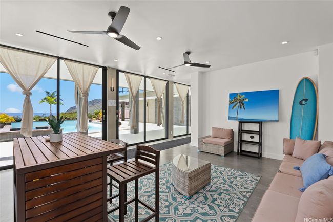 Lower living room area, perfect for indoor-outdoor experience with pool, elevator shaft area towards the left of this photo. | Image 15