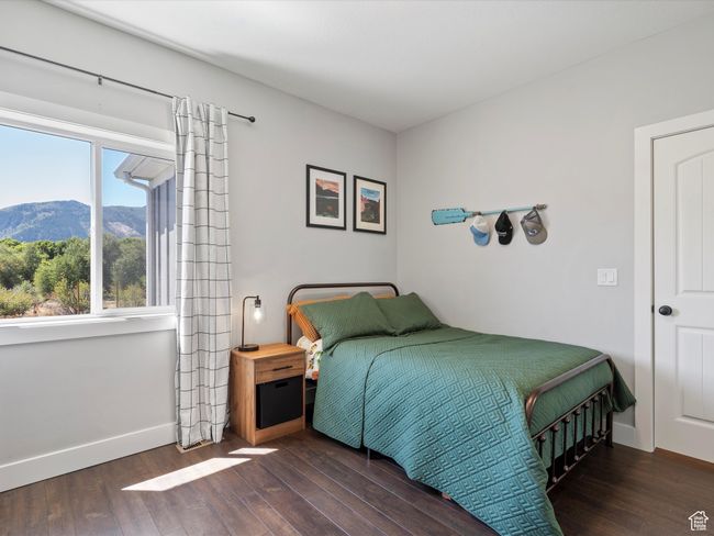 Bedroom featuring wood finished floors, a mountain view, and baseboards | Image 40