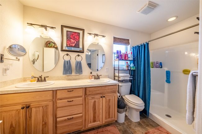 Full bathroom with a stall shower, visible vents, and a sink | Image 11