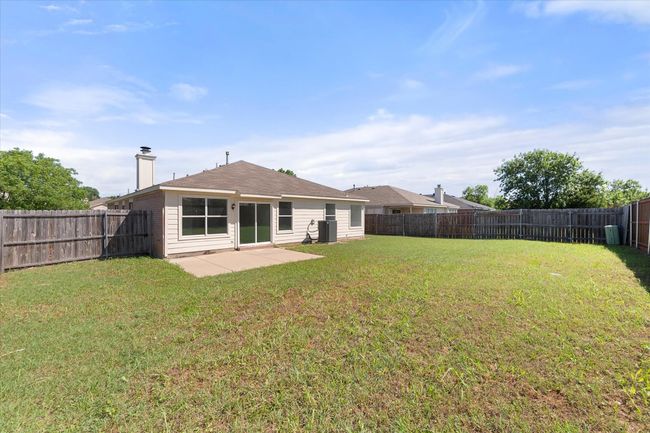 Back of house with central AC, a patio area, and a chimney | Image 25