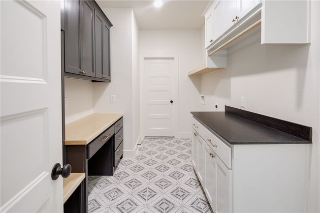 Laundry room featuring cabinet space, electric dryer hookup, baseboards, and light floors | Image 31