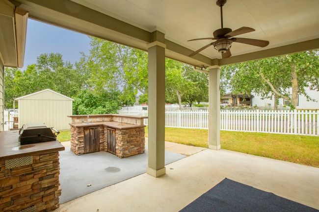 View of patio back terrace with an out door kitchen for amily BBQ's and a large covered patio | Image 27