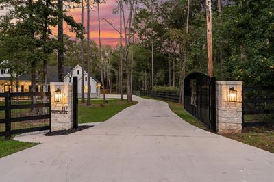 Fully fenced, this property also features an electronic entry gate which provides security to the homeowner and creates an amazing entrance to this home. | Image 3