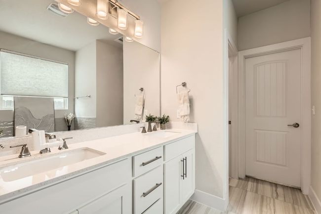Bathroom featuring double vanity and baseboards | Image 16