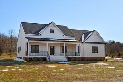 Modern farmhouse featuring a garage and a porch | Image 2