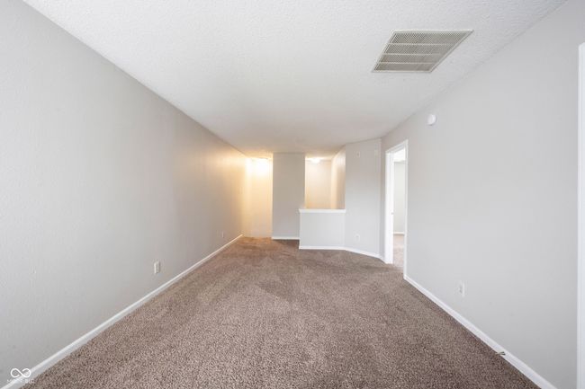 unfurnished room with carpet floors, visible vents, and baseboards | Image 28