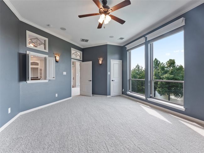 Unfurnished bedroom with ornamental molding, carpet flooring, and ceiling fan | Image 34