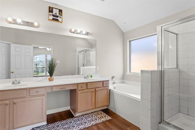 The Primary Bathroom has double sinks, a garden tub and a separate shower. | Image 12