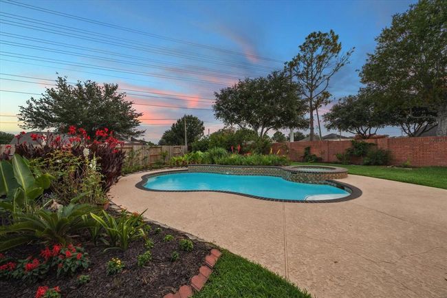 Entertain, relax, exercise and enjoy all the benefits of owning a house with a pool! Poolside charm and picturesque sunsets are yours to enjoy with no backyard neighbors! | Image 5