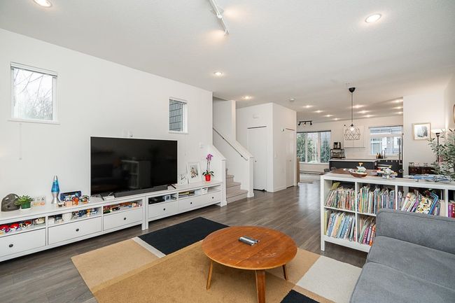 Living room with stairway, wood finished floors, and recessed lighting | Image 7