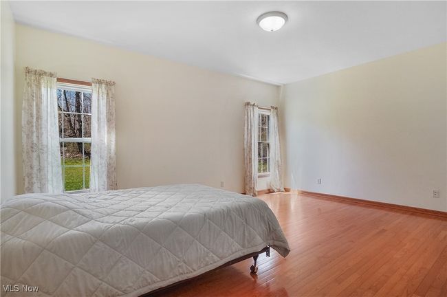 Bedroom featuring baseboards and wood finished floors | Image 29