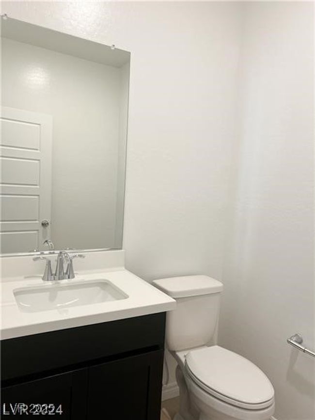 Downstairs Half bathroom featuring toilet, vanity | Image 9