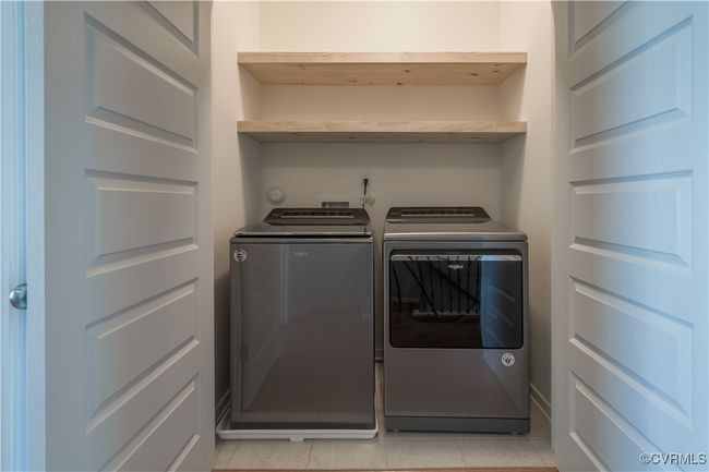 Washroom featuring hookup for a washing machine, light tile floors, and washing machine and clothes dryer | Image 12