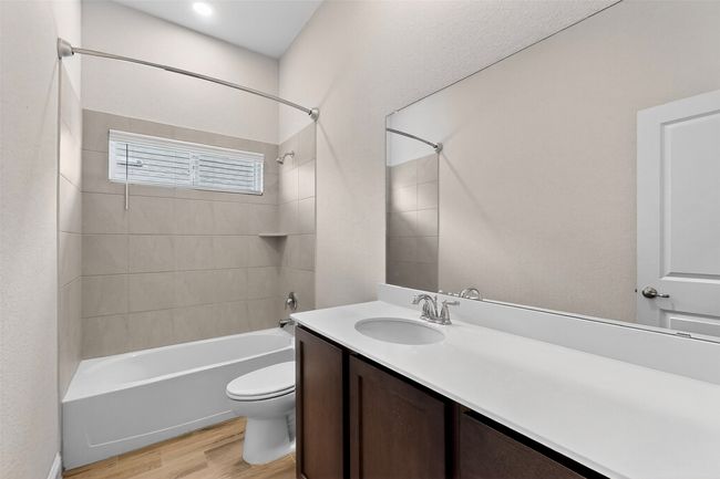 Full bathroom featuring wood finished floors, bathtub / shower combination, and vanity | Image 24