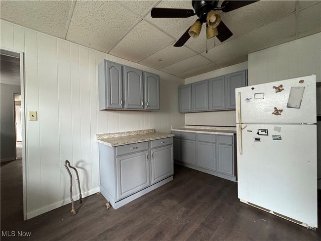 Kitchen featuring a paneled ceiling, dark wood-style floors, gray cabinets, and freestanding refrigerator | Image 16
