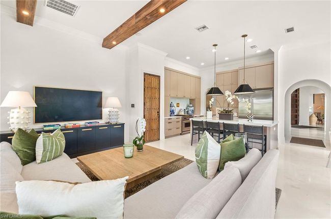 Living area with visible vents, arched walkways, and beamed ceiling | Image 10