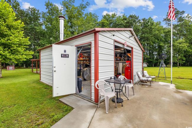 Garage featuring a workshop area | Image 31