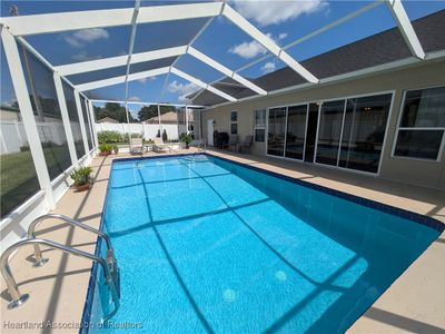 Take a refreshing dip in the sparkling blue, caged-in, heated pool | Image 3