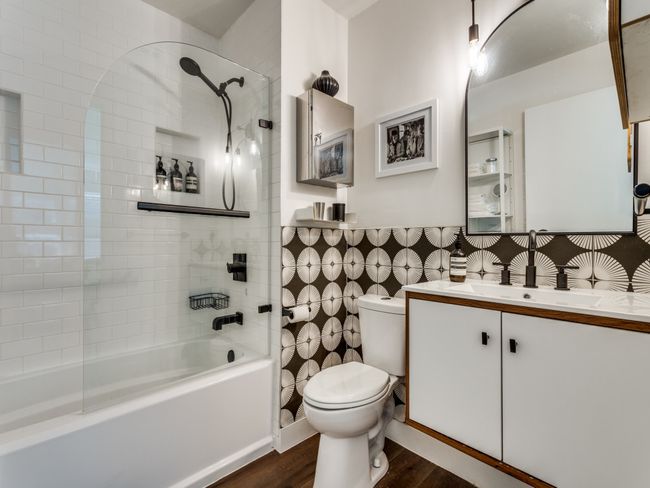 Full bathroom featuring toilet, shower / tub combination, wood finished floors, vanity, and wainscoting | Image 8