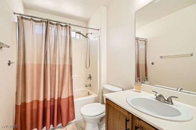 Full bathroom featuring toilet, shower / tub combo with curtain, and vanity | Image 24