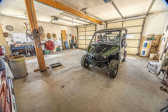Garage with electric water heater and a garage door opener | Image 14