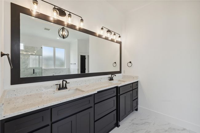 Bathroom featuring vanity and a shower with door | Image 30