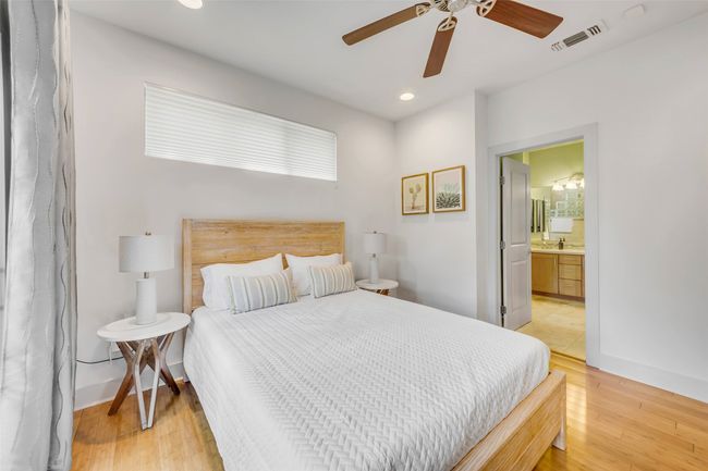 Bedroom featuring ceiling fan, hardwood / wood-style floors, and ensuite bath | Image 15
