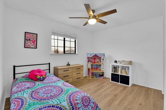 Bedroom featuring light wood finished floors and a ceiling fan | Image 27