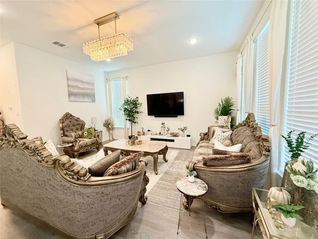 Living area with plenty of natural light, wood finished floors, and recessed lighting | Image 12