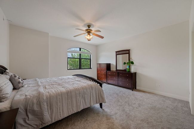 Carpeted bedroom featuring ceiling fan and baseboards | Image 30