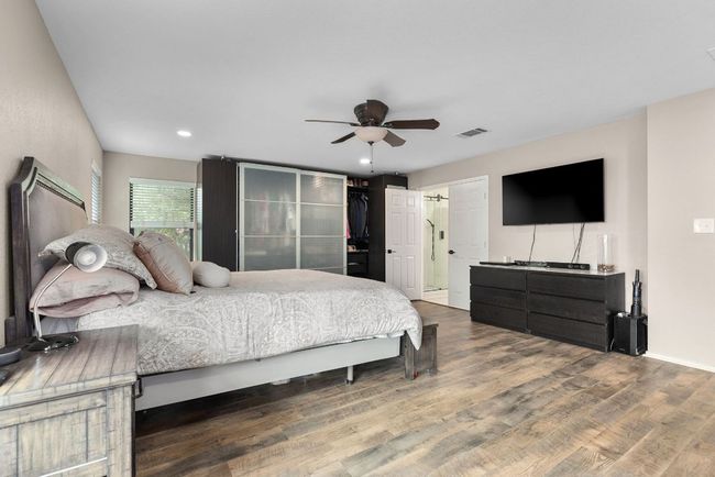 Bedroom with wood finished floors, recessed lighting, ceiling fan, and baseboards | Image 21