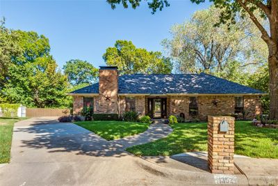 Ranch-style house with a J Swing driveway | Image 1