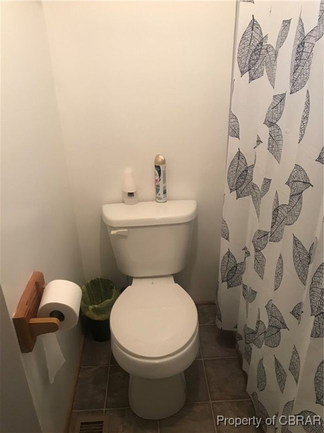 Bathroom featuring tile patterned flooring, walk in shower, and toilet | Image 10