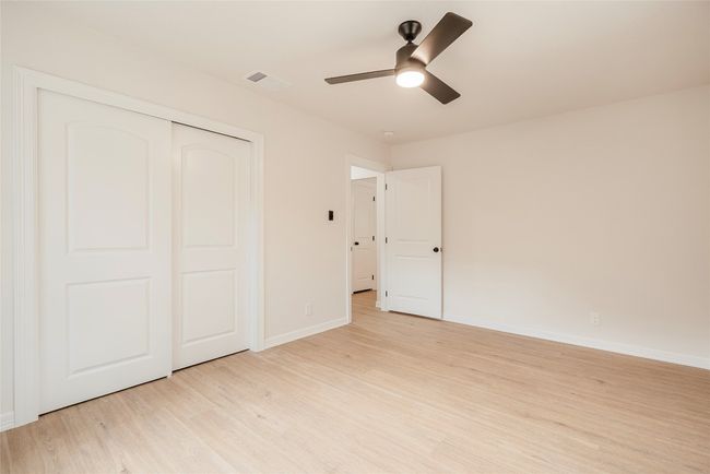 Unfurnished bedroom with light wood-type flooring, a closet, and a ceiling fan | Image 22