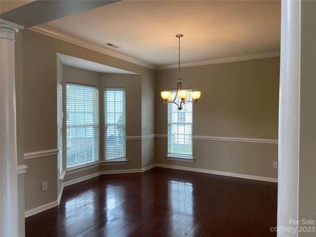 Dining room with chair rail and crown molding. | Image 4