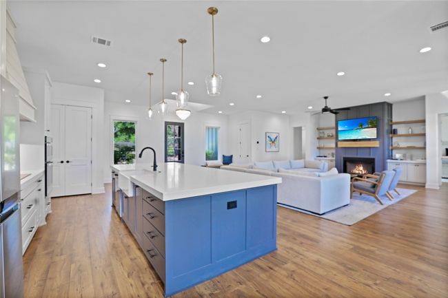 Kitchen featuring a fireplace, visible vents, recessed lighting, and light wood-style flooring | Image 13