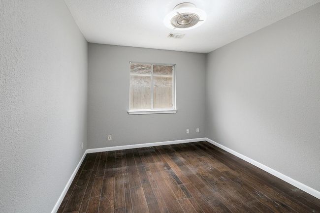 Empty room with visible vents, baseboards, and dark wood-style floors | Image 29