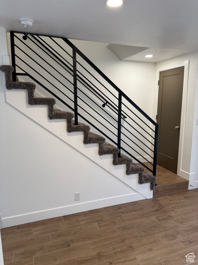 Staircase featuring baseboards, recessed lighting, and wood finished floors | Image 5