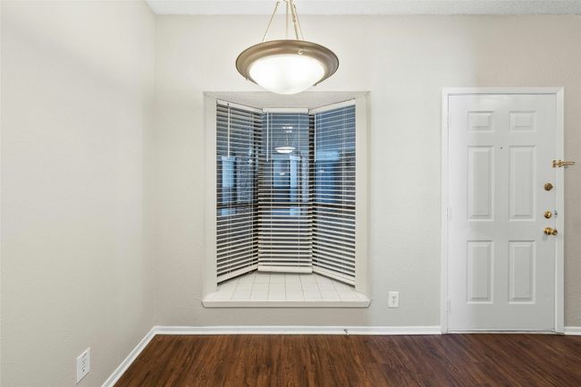 Entryway with baseboards and wood finished floors | Image 15